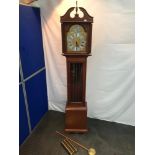 A Reproduction Tempus Fugit grandfather clock with weights and pendulum.