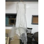 A Vintage Hand made Lace Wedding dress. Comes with vale.