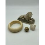 A 19th/20th century hand carved marble lion sculpture [13cm in length], 19th century ivory bangle,