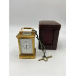 A Victorian miniature carriage clock with travel case. In a working condition, Comes with original
