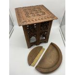 A small hand carved Indian style table together with a small wooden dust brush and shovel. Table
