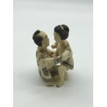 A Japanese Meiji period hand carved bone erotic netsuke figures. Highly detailed man and women