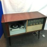 A Vintage Consort Radio cabinet fitted with a BSR Turntable. Designed on pedestal legs, Not