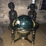A Semi precious stone globe sat within a brass stand. Together with two reproduction girl and boy