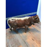 Rare antique cow toy Covered with cow hide and designed with an aperture to the top of the back