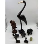 A Lot of various carved collectables which includes Large Bird, Three Elephants, Two antelopes,