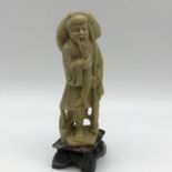 An Antique hand carved Chinese soapstone fisherman figurine. Measures 15cm in height.