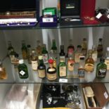 A Shelf of collectable whisky miniatures [all sealed] to include Drambuie, Chivas Regal, Dimple,