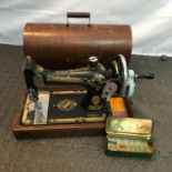 A Vintage Singer sewing machine serial number EB593352. Comes with instruction booklet and carry