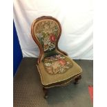 A Victorian spoon back nursing chair, upholstered with a floral bead work design.