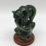 A Vintage hand carved oriental green jade bear figure sat upon a rock. Measures 8cm in height.