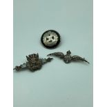 Three silver military badges which includes Sterling silver R.A.F Winged badge, Birmingham silver