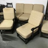 A vintage Ercol three piece cottage suite with footstool . Nicely upholstered and comes with other