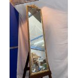 A Vintage Full length bevel edge mirror designed with an ornate gilt frame. Measures 133x34cm