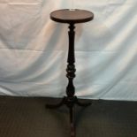 A Mahogany pedestal torcher stand. Supported on tri- legs. [96cm in height]