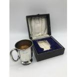 A Birmingham silver christening mug with fitted box. Measures 8.2cm in height. Weighs 77.6grams
