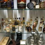 A Shelf of collectable whisky miniatures [All sealed] to include Johnnie Walker Red Label, Bells,