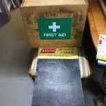 A Vintage Tin Lyons Quality Cakes writing board together with a First Aid box. Lyons board