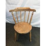 Antique light wood child's spindle back chair.