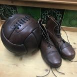 A Reproduction hand stitched leather football together with a pair of vintage leather football