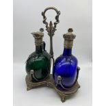 A pair of early 1800's blue and green hand blown claret jugs with plated lids & stoppers. Fitted