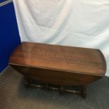 A vintage Ercol elm wood drop end coffee table. Measures 49x107x91cm extended.