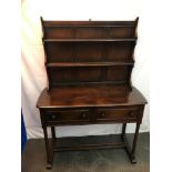 A vintage Ercol elm wood dining room dresser. Supported on 4 turned pedestal legs. Designed with two