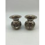 A Pair of small Indian silver vases. Ornately made detailing Animals, lodgings and foliage. [6.8cm