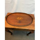 A Georgian two handle mahogany serving tray, detailed with a centre inlaid musical instruments
