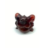 Early 20th century Japanese hand carved amber netsuke of a sumo wrestler. Signed by the artist.