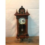 Antique style wall clock with key and pendulum. Measures 62cm in length