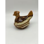 A 19th century Earthen ware slip ware hen money bank. Measures 8x11x7.5cm