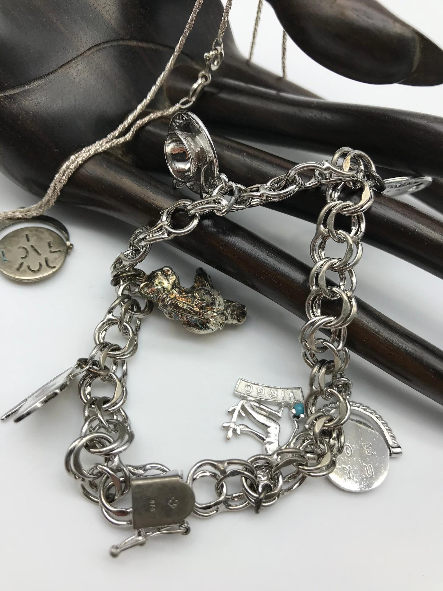 A heavy Sterling silver charm bracelet with various charms, Silver baby bangle and silver necklace - Image 2 of 4