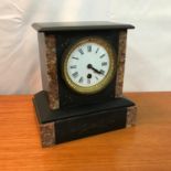 A Victorian slate and marble cased French mantel clock, In a working condition. Comes with key and