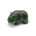 A Oriental Hand carved Jade bear holding a fish within its mouth sculpture. Measures 4x6.5x4cm
