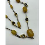 A Vintage ladies necklace designed with amber and glass beads. [20 inch drop].