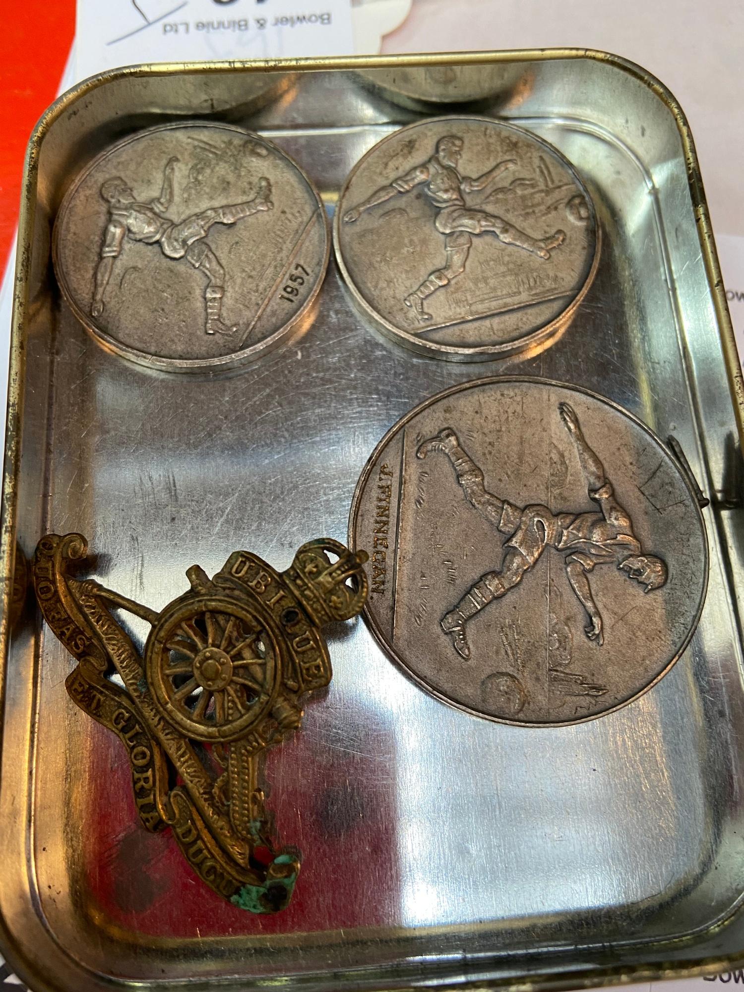 Artillery cap badge and three Vintage Army Cadet Force football medals presented to SGT. J FINNIGAN.