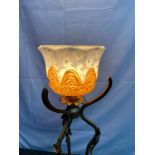 An art Nouveau cast metal base free standing light, set with an ornate painted shade. Measures 81.
