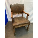 A Victorian Ships oak carver chair. Upholstered with original leather and stud finish. Fitted with