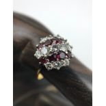 A Beautiful example of a ladies Diamond and Ruby cluster ring. Possibly Set with a high gold and