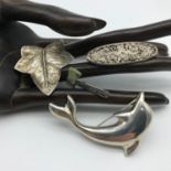 A Lot of 4 silver brooches to include Viking style and green stone axe brooch, Large Dolphin