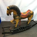 Hard wood carved and painted rocking horse. Has horse hair tail and glass eyes. Needs