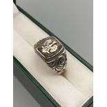 A Vintage military style signet ring detailing a crowned phoenix. Stamped IR. Also stamped to the