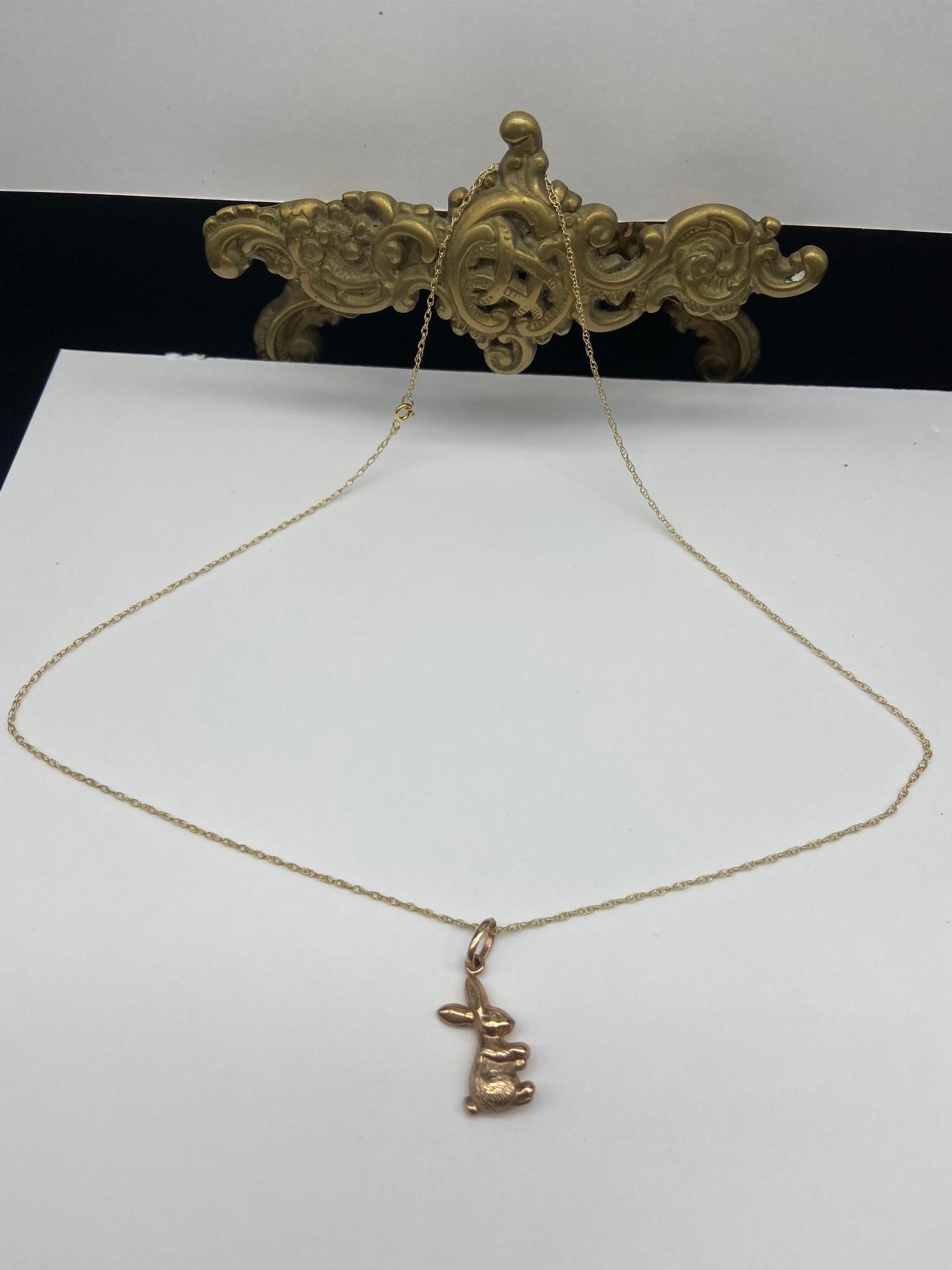 A 9ct gold rabbit pendant with a 9ct gold necklace. [Weighs 1.53 grams] [16 inch chain]