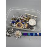 A Tub of mixed military collectables to include cap badges, bars and includes Ingersoll pocket watch