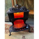 Antique French cast iron wood burning stove, Fitted with a modern light fitting to the top. [