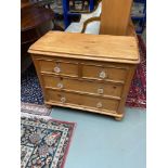 A 19th century antique pine two over two chest of drawers fitted with glass ornate handles.