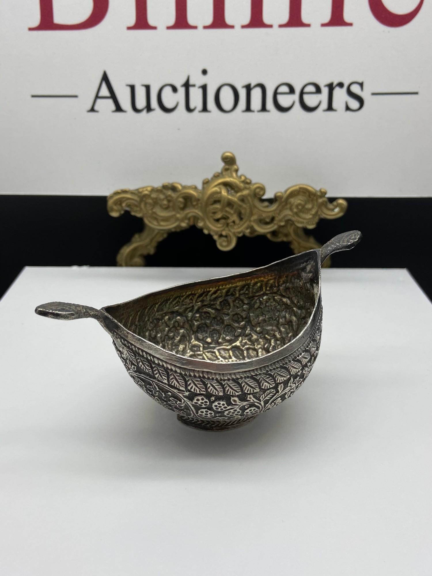 Antique Indian silver two handled drinking vessel/ cup. Handles are in the style of snake heads.[