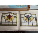 A Pair of Antique stain glass window panels detailing a flower to the centre. [As Found]