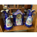 A Radfordian Crown Art Ware Antique porcelain mantel clock with two matching garniture urn vases.